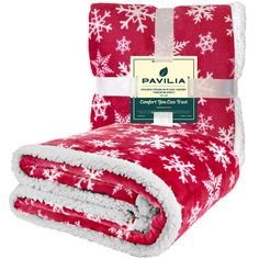 the red and white blanket has snowflakes on it, with a tag that says pavillia