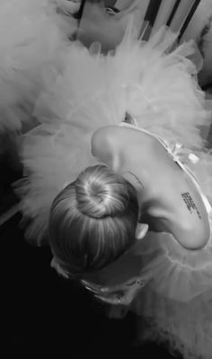 black and white photograph of a woman with her back turned to the camera, wearing a tutu