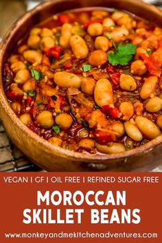 a wooden bowl filled with moroccan skillet beans