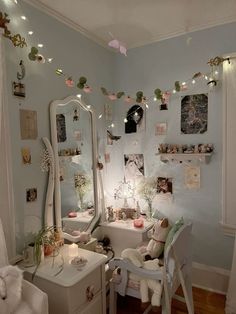 a room filled with furniture and lots of lights hanging from the ceiling next to a mirror