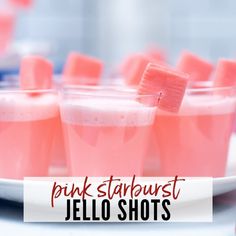 pink starburst jello shots with toothpicks in them on a plate