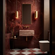 a bathroom with a toilet, sink and mirror on the wall next to a checkered floor