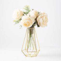 a vase filled with white flowers sitting on top of a table