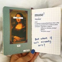 a hand holding an open book with a note attached to the inside of it that says,'museum '