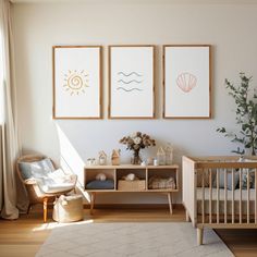 a baby's room with three framed pictures on the wall