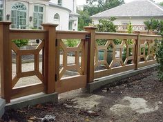 a wooden fence in front of a white house