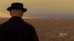 a man in a hat standing in a field