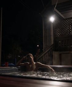 a man is in the hot tub at night