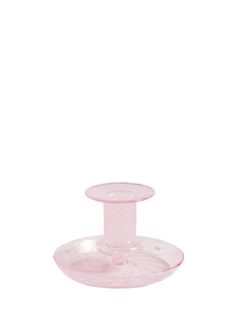 a pink glass candle holder on a white background