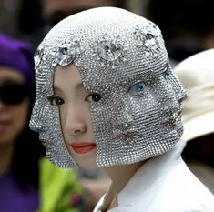 an image of a woman wearing a headdress with many jewels on her head