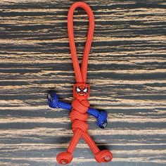 a red and blue rope with a spiderman figure hanging from it's end