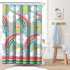 a shower curtain with rainbows, clouds and hearts on it in a bathroom setting