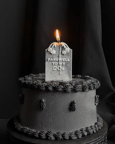 a black and white photo of a cake with a lit candle on top that says farewell to my 205