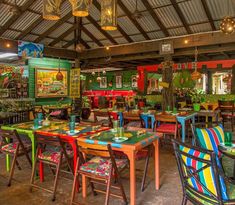 an outdoor restaurant with colorful tables and chairs