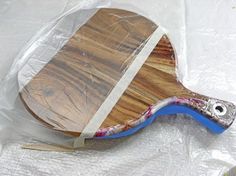 a close up of a wooden paddle on a plastic bag