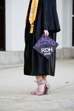 a woman in a graduation gown is holding a sign that reads, called scad it rdh 2013