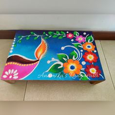 an artistically painted wooden bench on the floor