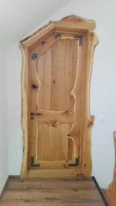 a large wooden door sitting inside of a room