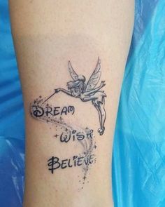 a tattoo on the leg of a woman with words written below it and an image of a fairy