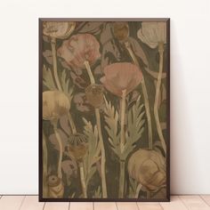 a painting on the wall with flowers and leaves painted on it's side, in front of a wooden floor