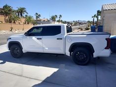 a white truck parked in front of a house