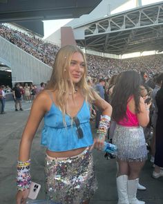 a woman in a sequin skirt at a football game with other people standing around