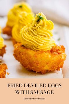 fried deviled eggs with sausage on a white plate and text overlay reads fried deviled eggs with sausage