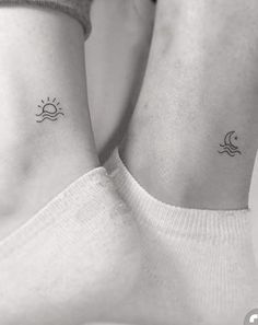 two small sun and moon tattoos on the wrist