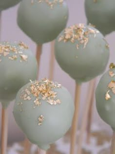 green cake pops with gold sprinkles on top are ready to be eaten