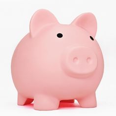 a pink pig toy sitting on top of a white surface