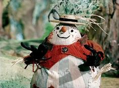 a snowman made out of cloth with gloves and a hat on it's head