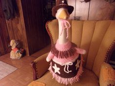 "This Cowgirl goose geese outfit is hand crocheted with pink white and brown yarn There is fringe on the top and bottom of the skirt There is a white bow at the waistline with two white star on the skirt The hat has a white plastic star on it This can also convert to a gnome girl just by bringing the hat forward further over the beak This fits the 24\" plastic goose Will not fade in the sunlight Have over 195 different design of geese outfits This includes over 35 GNOME geese outfits" Goose Clothes Pattern Free, Yard Goose, Lawn Goose Clothes, Ugly Sweater Outfits, Goose Costume, Duck Clothes, Concrete Goose, Goose Outfits, Crochet Goose