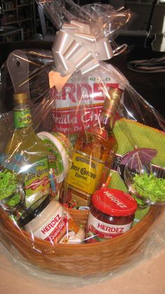 a basket filled with lots of food and condiments on top of a table