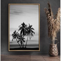 a black and white photo with palm trees on the beach in front of a vase