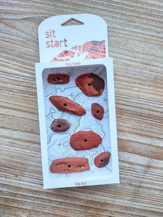 a package of wooden buttons sitting on top of a wooden table