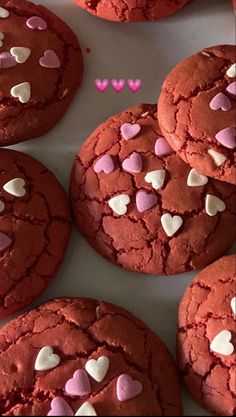 red velvet cookies with pink and white hearts on them are arranged in a grid pattern