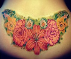 a close up of a woman's stomach with flowers on the side and chest