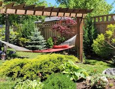 a hammock in the middle of a garden