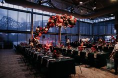 a room filled with tables covered in black and red decorations