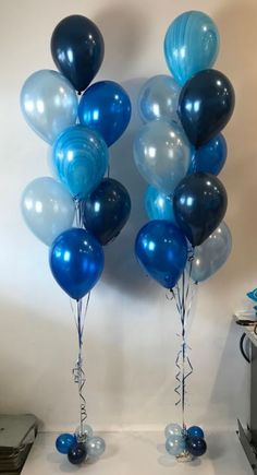 some blue and silver balloons are on the table