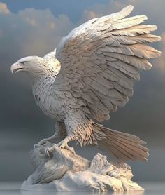 a white bird with outstretched wings sitting on top of a rock