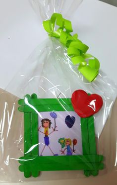 there is a plastic bag with a picture frame on it and a heart in the middle