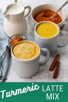 three mugs filled with different types of food on top of a white tablecloth