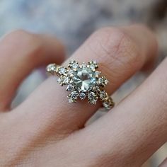 a close up of a person's hand with a ring on it