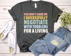 You don't scare me I successfully negotiate with toddlers for a living Shirt - Unisex T Shirt, Women Racerback Tank, Long Sleeve T-Shirt Tees Tshirt Sweatshirt Sweater Hoodie Gift For Men Women Boys Girls Nanny Shirt / You don't scare me. I successfully negotiate with toddlers for a living. Teacher PreK Shirt Well, let's say goodbye to all this boring apparel... The GodBlessThisDesign team creates custom clothes with great designs to suit all tastes. Our unique and blessed designs are a blast fit for every occasion and always a perfect fit... We combine our beautiful designs with high quality apparel like no one has ever done before. There's nothing worse than being charmed by a nice design and then finding that the apparel with that design looks like an old cheap and mediocre quality appa Recycled Shirts, Paris Shirt, New York T Shirt, California Shirt, Lilac White, Aunt Shirts, Blue Lilac, Squad Shirt, Aesthetic Shirts