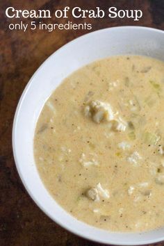 a white bowl filled with soup on top of a wooden table