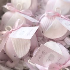 pink baby shoes and tags in a box