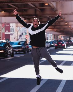 a man jumping in the air with his arms wide open