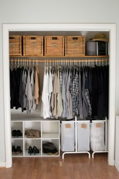 an organized closet with clothes and baskets