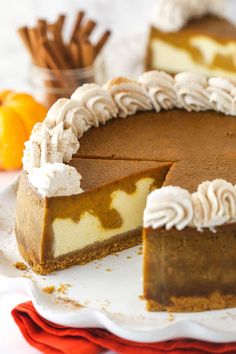 a slice of pumpkin pie on a plate with the rest of the pie in the background